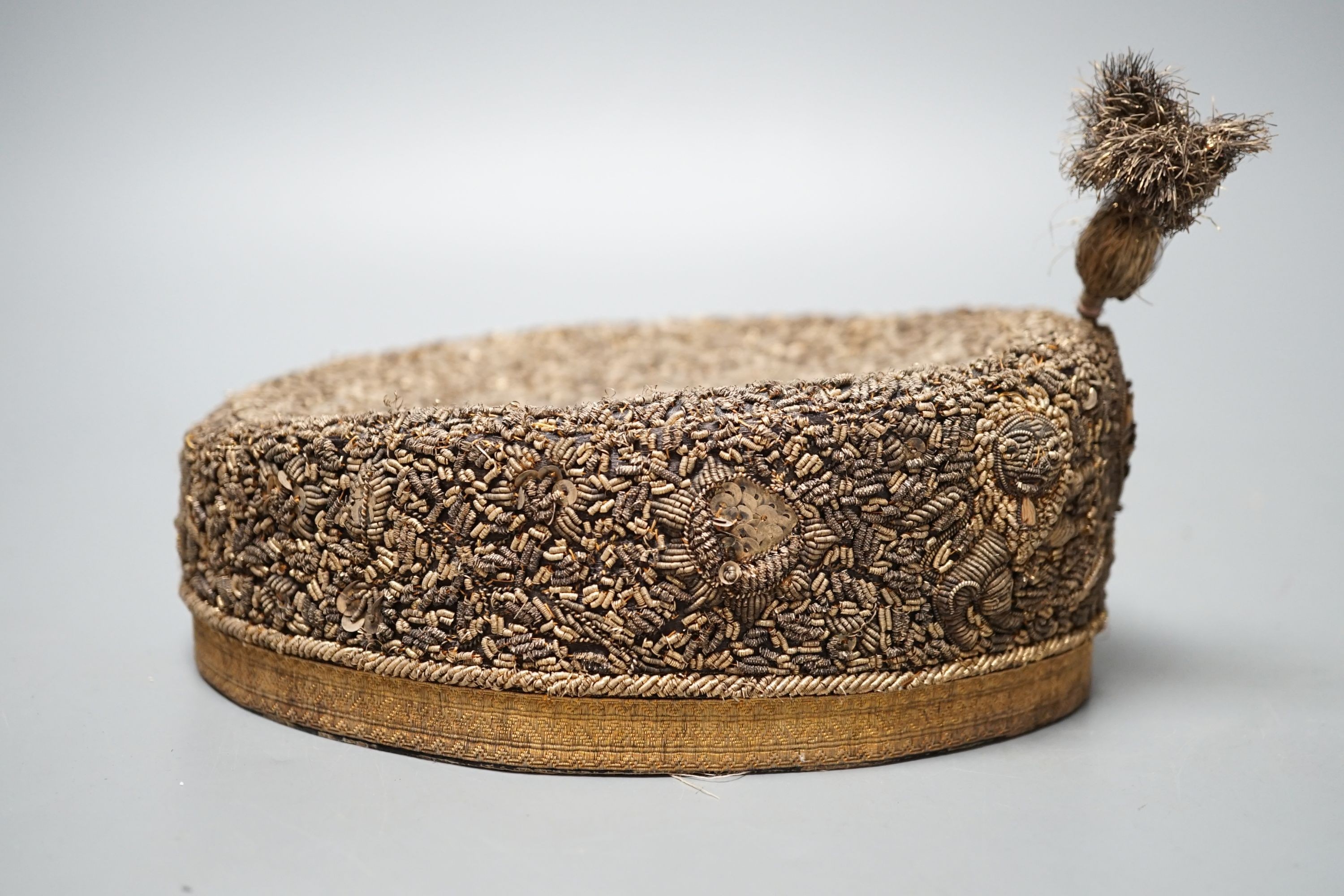 An Indian heavily embroidered cap with sequins and gilt thread 18cm